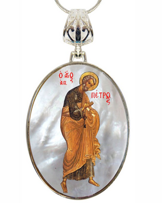 a pendant with a religious icon of a saint, and there is a small inscription above the icon.