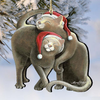 A pair of cats wearing Santa hats, appearing to be hugging each other, with snowflakes in the background.