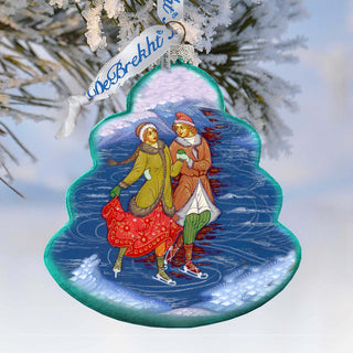 A decorative ornament featuring a couple ice skating on a frozen lake, surrounded by snow and trees.