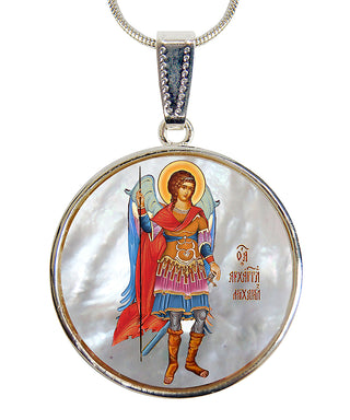 a round pendant with a depiction of a saint or religious figure, possibly a saint or religious icon, wearing a red robe and holding a staff or weapon.