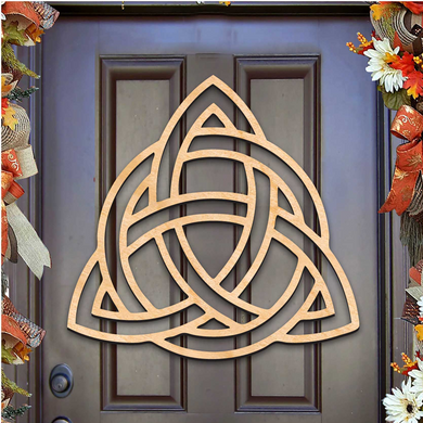 a wooden door with a carved Celtic knot design on it, surrounded by autumn-themed decorations.
