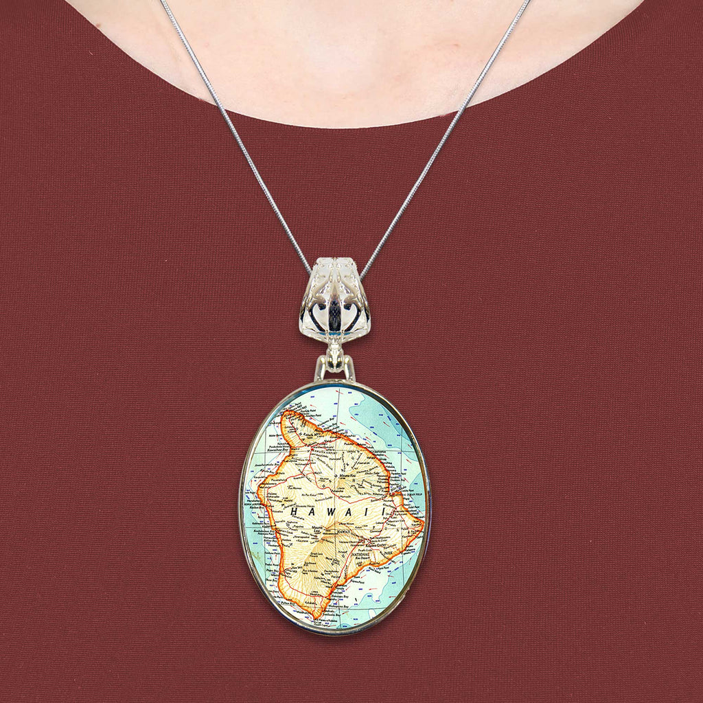 A necklace with a pendant featuring a map of Hawaii.