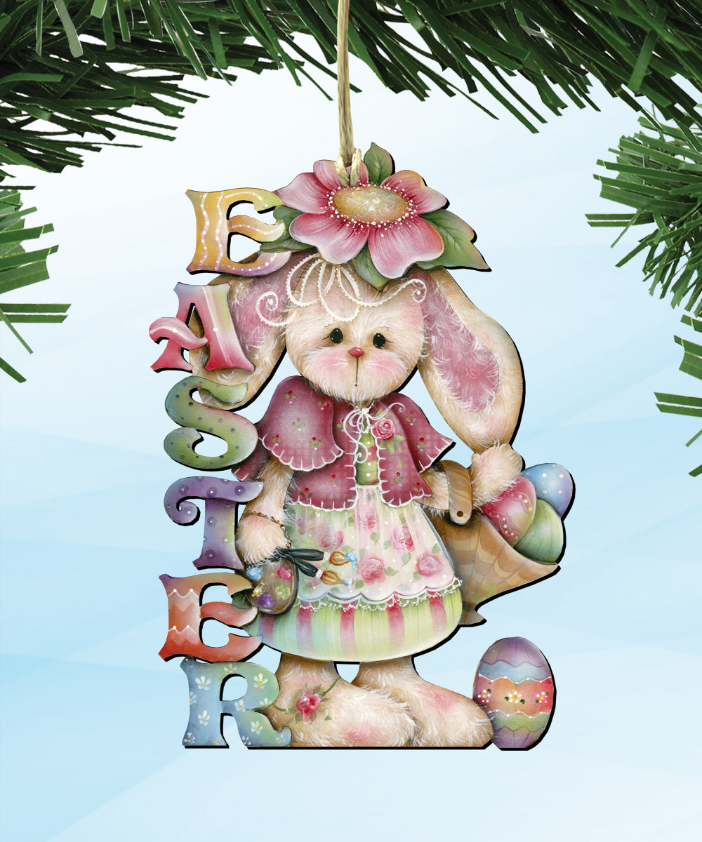 A colorful Easter ornament featuring a bunny wearing a pink dress and holding a flower, with the word 