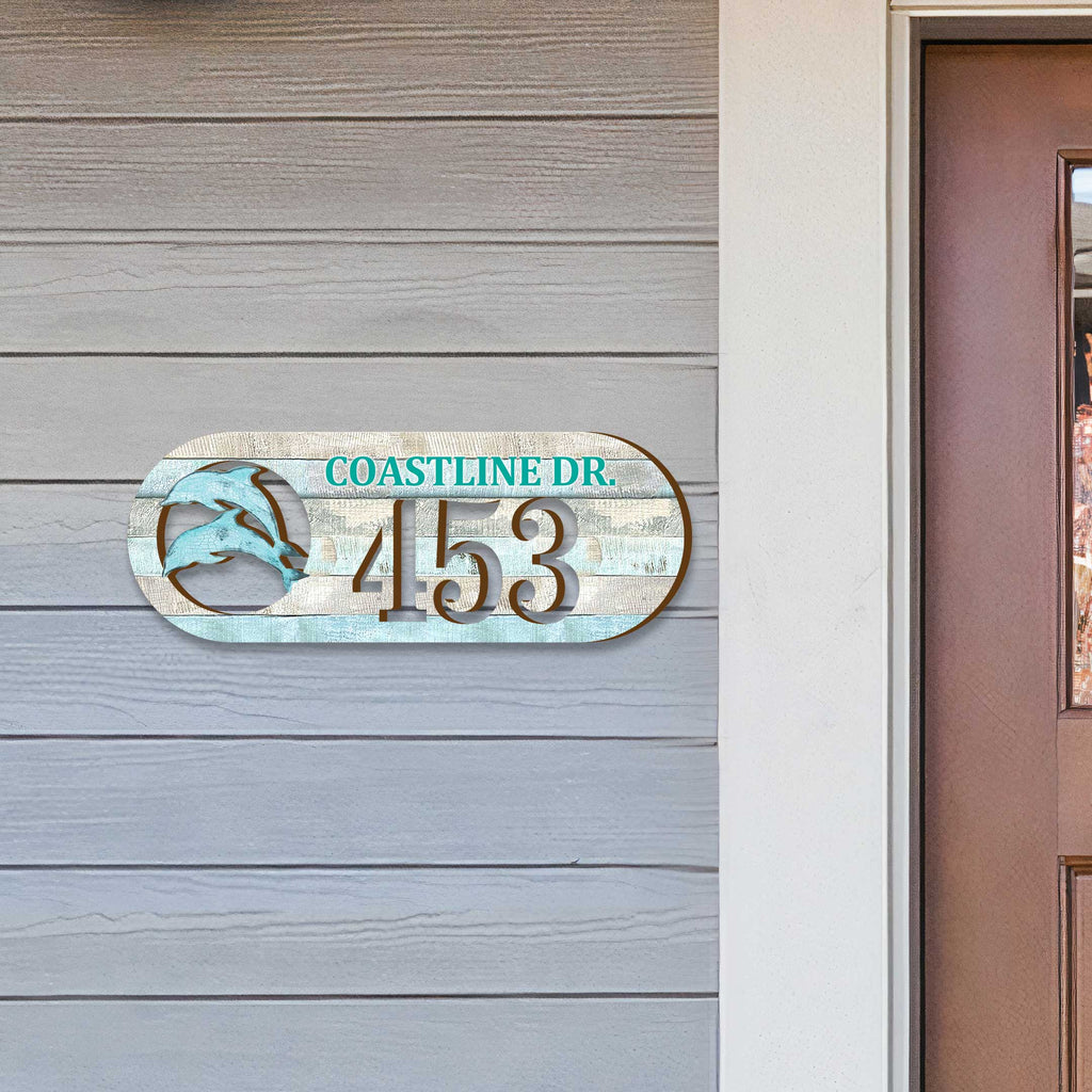 Oval coastal address plaque featuring dolphin cutout, house number 453, and customizable COASTLINE DR. street name, handcrafted by GDebrekht Artistic Studio. Perfect for nautical house numbers, coastal door decoration, beach house decor, and outdoor holiday decorations.