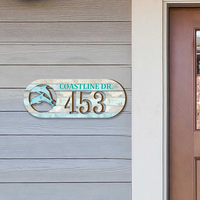 Oval coastal address plaque featuring dolphin cutout, house number 453, and customizable COASTLINE DR. street name, handcrafted by GDebrekht Artistic Studio. Perfect for nautical house numbers, coastal door decoration, beach house decor, and outdoor holiday decorations.