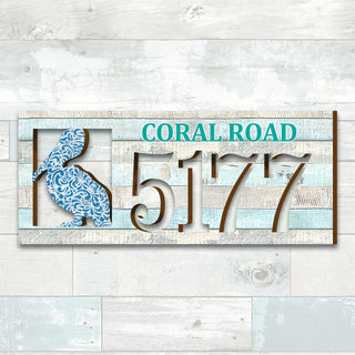 Coastal address plaque with blue pelican cutout, house number 5177, and customizable CORAL ROAD street name, handcrafted by GDebrekht Artistic Studio. Perfect for nautical house numbers, coastal door decoration, beach house decor, and outdoor holiday decorations.
