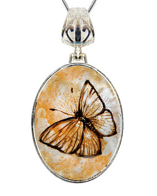 A silver pendant with a round, circular design featuring a detailed, colorful butterfly.