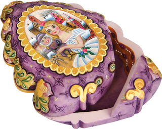 a purple and gold box with a painted scene of a girl and a nutcracker.