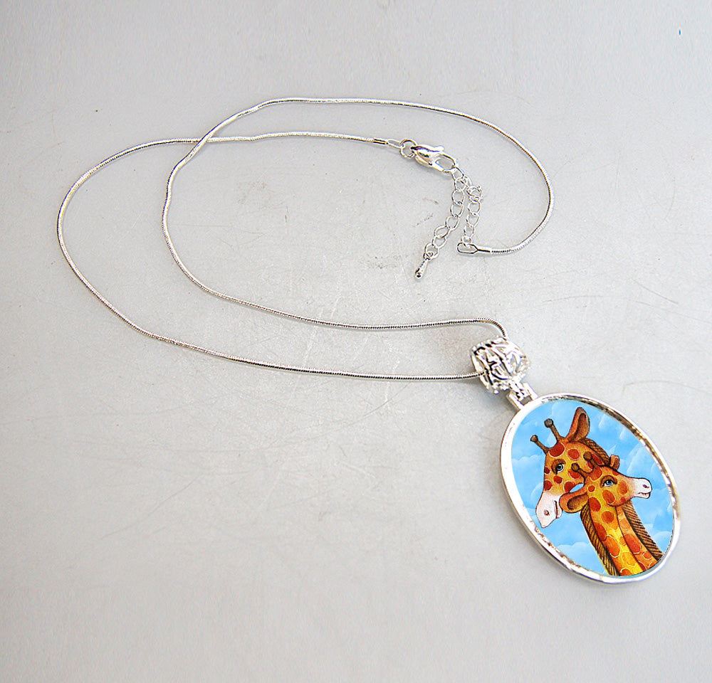 A silver necklace with a pendant featuring a giraffe image.