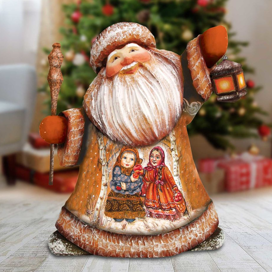 A wooden Santa Claus figurine holding a lantern and a basket of presents, with a Christmas tree in the background.