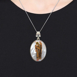 A silver necklace with a pendant featuring an image of a religious figure.