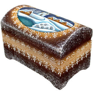 A decorative wooden box with a winter landscape painted on it, featuring a snowy scene with houses and trees.