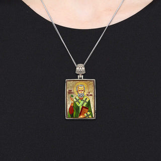 A silver necklace with a rectangular pendant featuring an image of a religious figure.