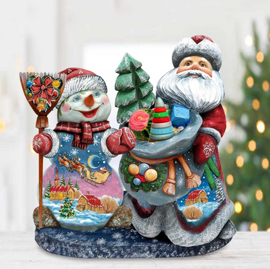 A colorful Christmas-themed figurine depicting Santa Claus and a snowman, both holding various holiday-themed items such as a toy train, a gift bag, and a red bow.
