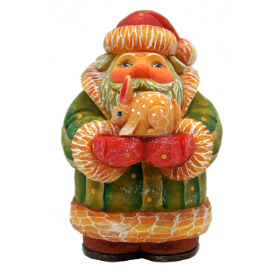 A colorful figurine of Santa Claus holding a small deer.