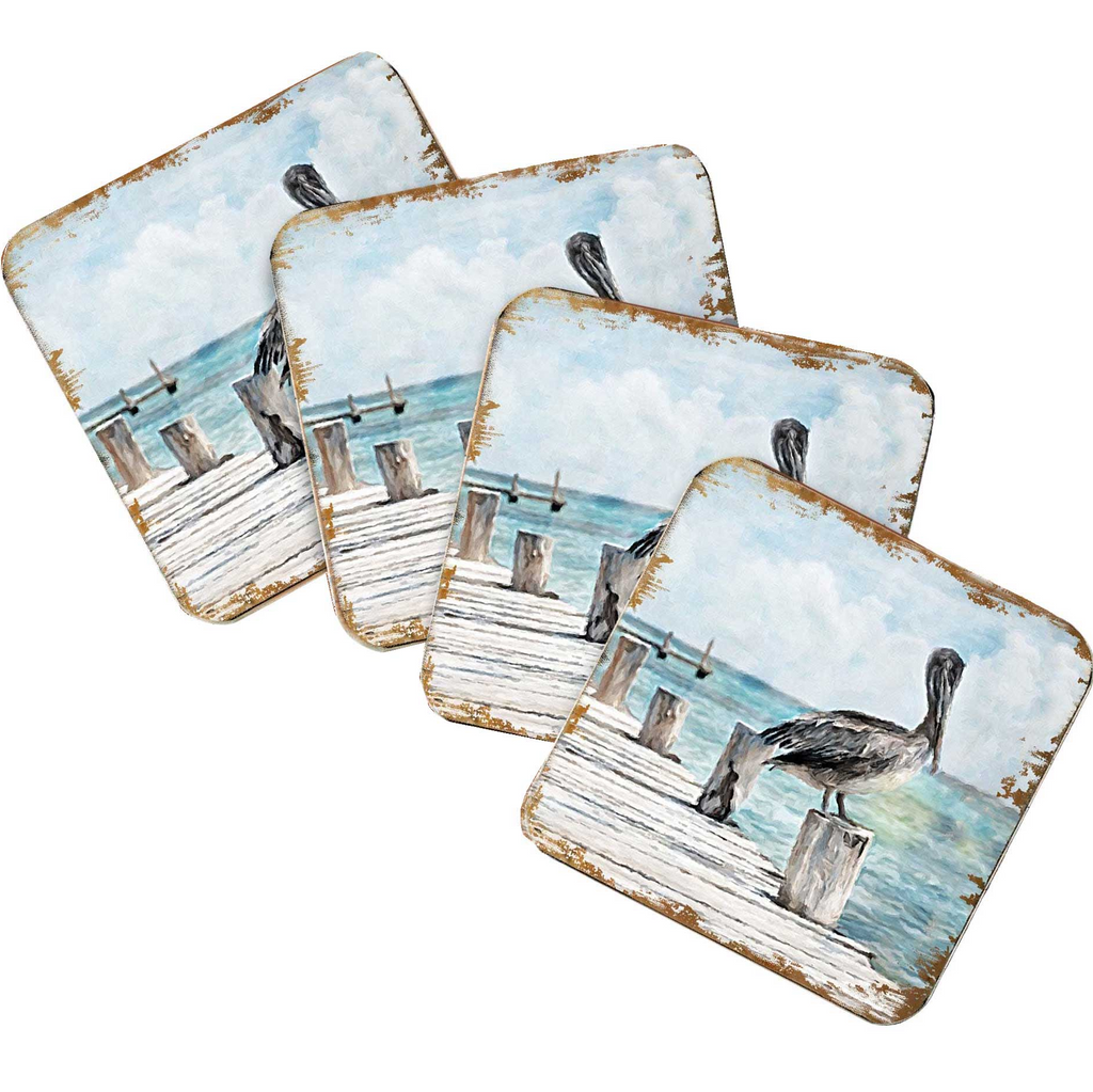 A set of four coasters featuring a seagull standing on a wooden dock overlooking the ocean.