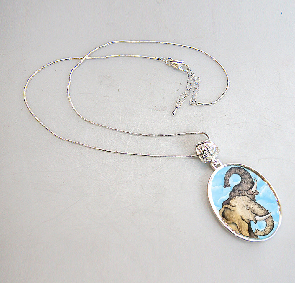 A silver necklace with a pendant featuring an elephant design.
