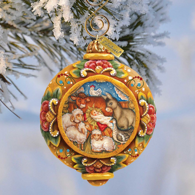 A decorative Christmas ornament featuring a nativity scene with animals, including sheep, goats, and a baby lamb, surrounded by a snowy landscape.