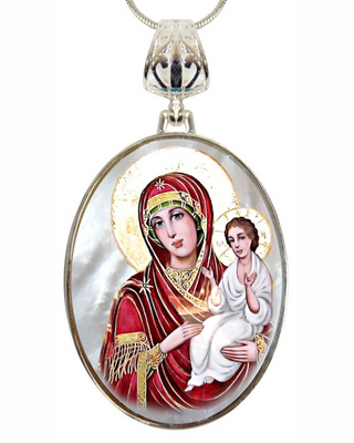 a necklace pendant featuring a religious icon of the Virgin Mary holding the baby Jesus.