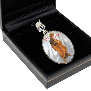 a pendant with a religious icon, displayed in a black box.