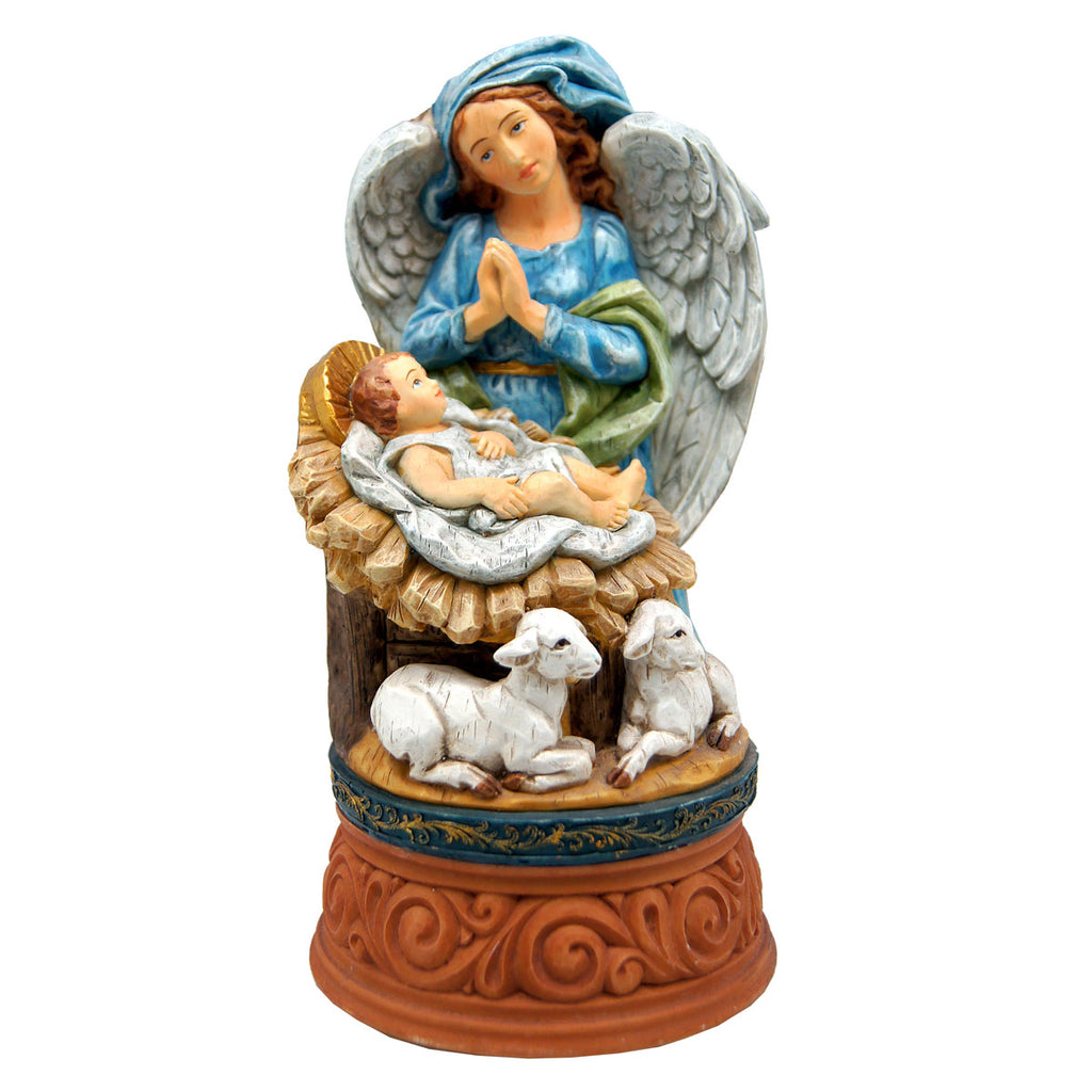 A figurine depicting a nativity scene with a baby in a manger, an angel, and two sheep.