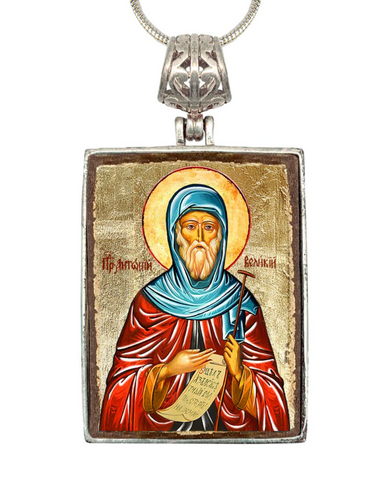 a religious icon of a bearded man wearing a red robe and a blue headscarf, holding a book and wearing a blue head covering.