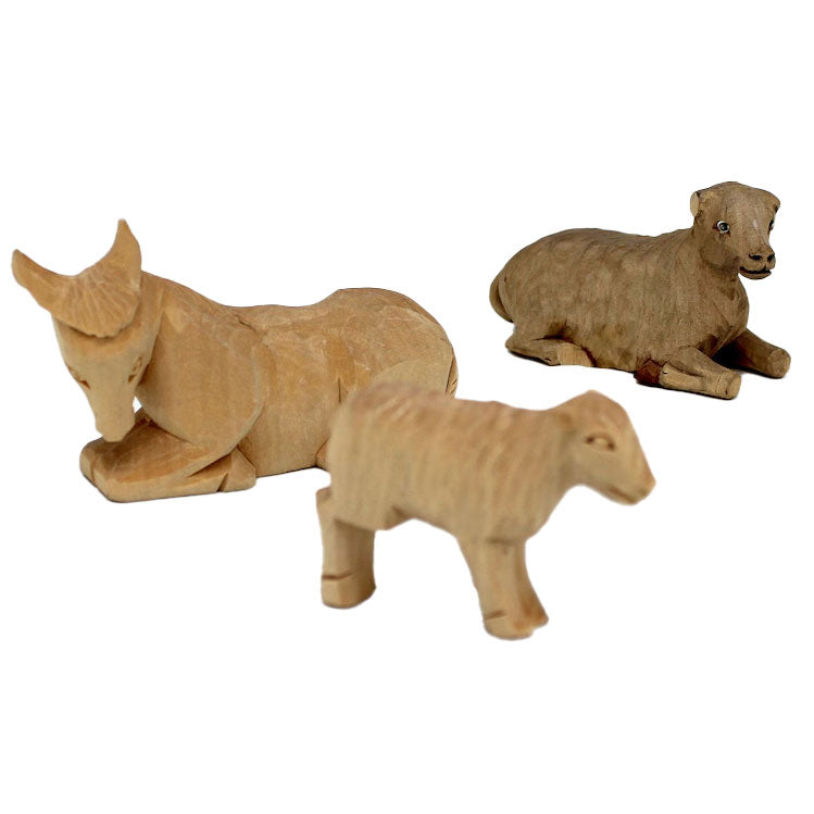 Three wooden animal figurines are arranged in a row against a white background.