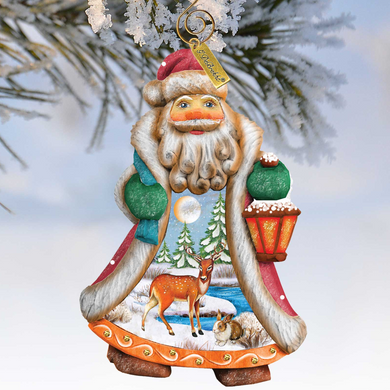 A colorful ornament depicting a Santa Claus figure with a lantern, surrounded by snow and pine trees, hanging on a tree branch.