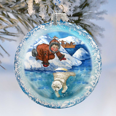 A decorative ornament featuring a polar bear swimming in the water, with a person in a red coat and hat standing on a snowy surface in the background.