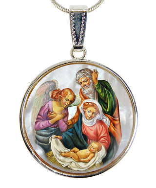 A pendant featuring a religious scene with a baby Jesus, angels, and a man in a green robe.