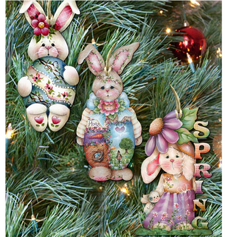 three colorful Easter bunny ornaments hanging on a Christmas tree.