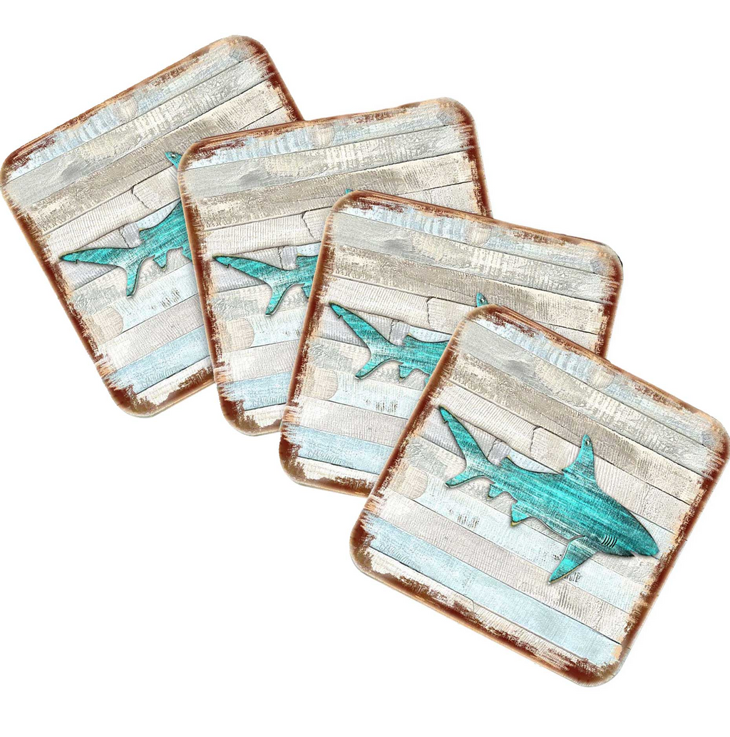 four square coasters with a design of a shark on them.