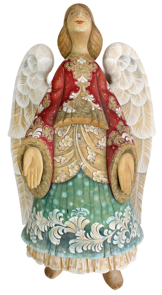 A wooden statue of an angel with white wings and a red and gold dress, standing against a black background.