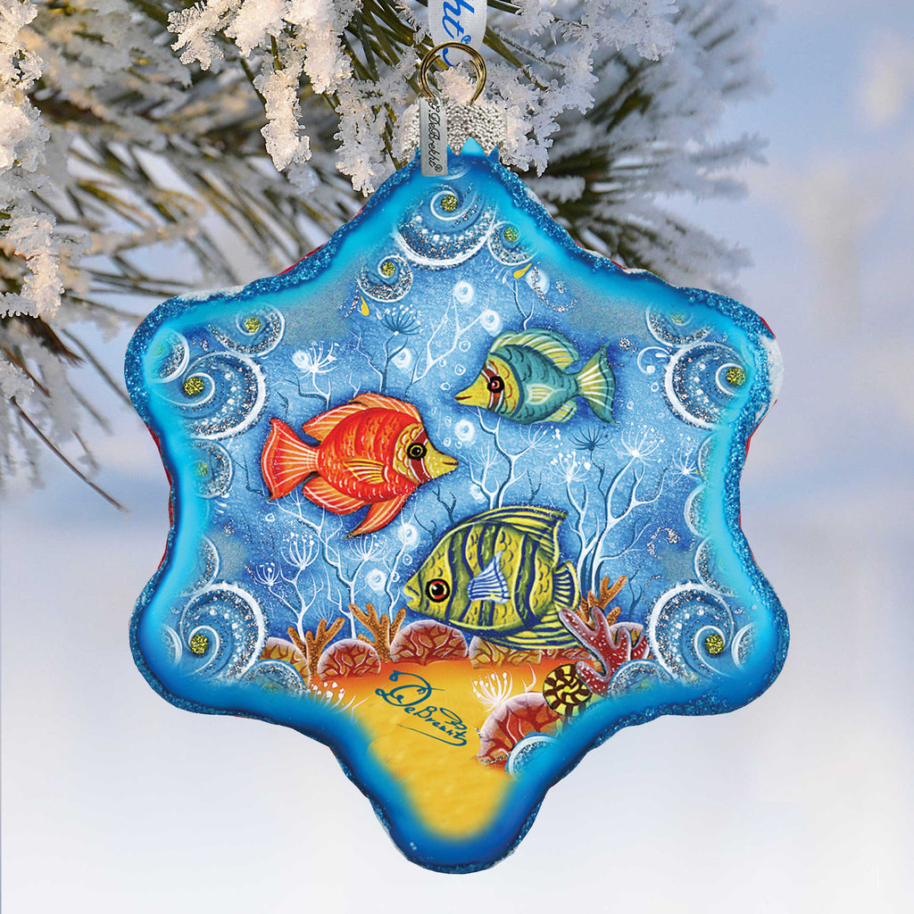 A blue star-shaped ornament with a painting of colorful fish swimming in the ocean.