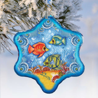 A blue star-shaped ornament with a painting of colorful fish swimming in the ocean.