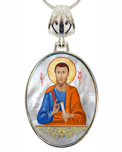 a pendant with a religious icon of a bearded man wearing a blue robe and holding a book.