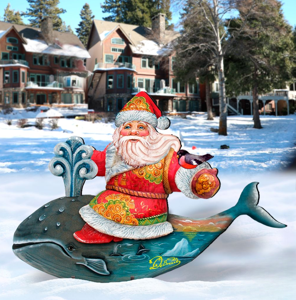A colorful Santa Claus figurine is riding on a whale in a snowy landscape, with a row of houses and trees in the background.