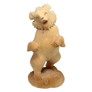 A wooden sculpture of a bear standing on its hind legs.