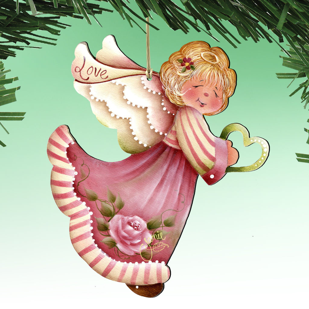 A pink and white angel ornament with a heart-shaped pendant and the word 