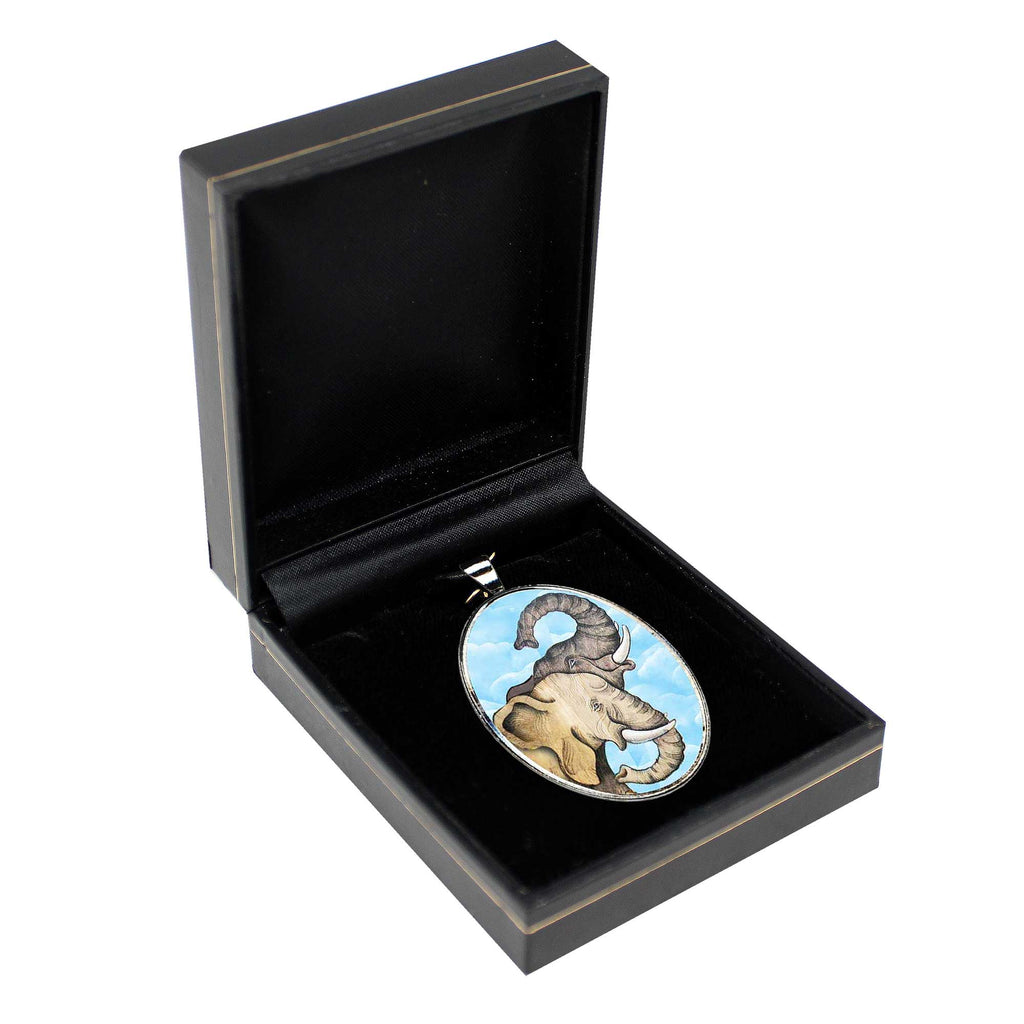 a pendant with an elephant design, displayed in a black jewelry box.