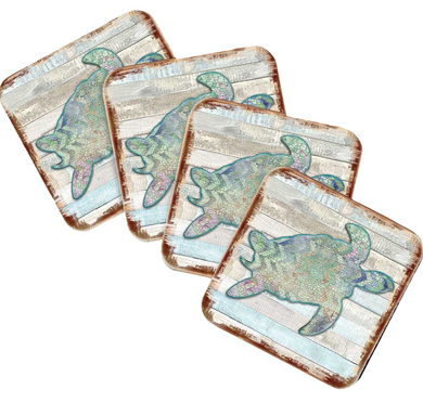 four square coasters with a design of a green and blue sea turtle.