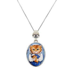 A silver necklace with a circular pendant featuring an illustration of a cat wearing a blue dress and holding a kitten.