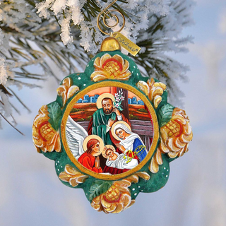 A decorative ornament hanging on a tree branch, featuring a religious scene with a man, a woman, and a baby.