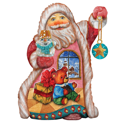A colorful and whimsical Christmas ornament depicting Santa Claus holding a snowman, a teddy bear, and a gift box, with a star decoration hanging from Santa's hand.
