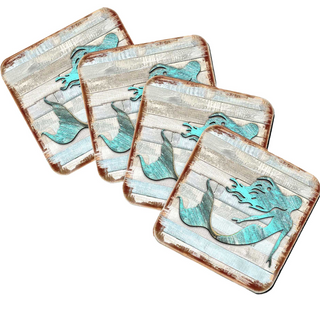 four square coasters with a mermaid design on them.