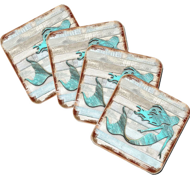 four square coasters with a mermaid design on them.