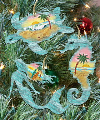 a Christmas tree decorated with various ornaments, including a mermaid, a seahorse, and a turtle.