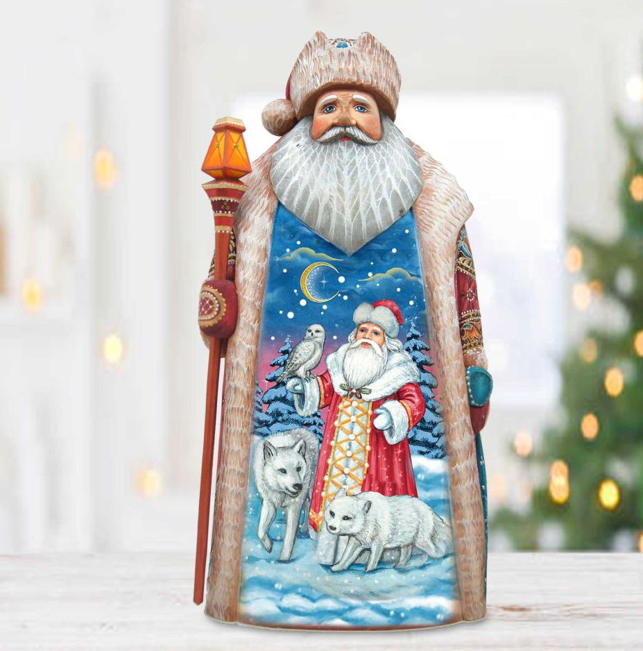 A figurine of Santa Claus holding a lantern and a bird, set against a snowy winter landscape with a wolf and a wolf cub.