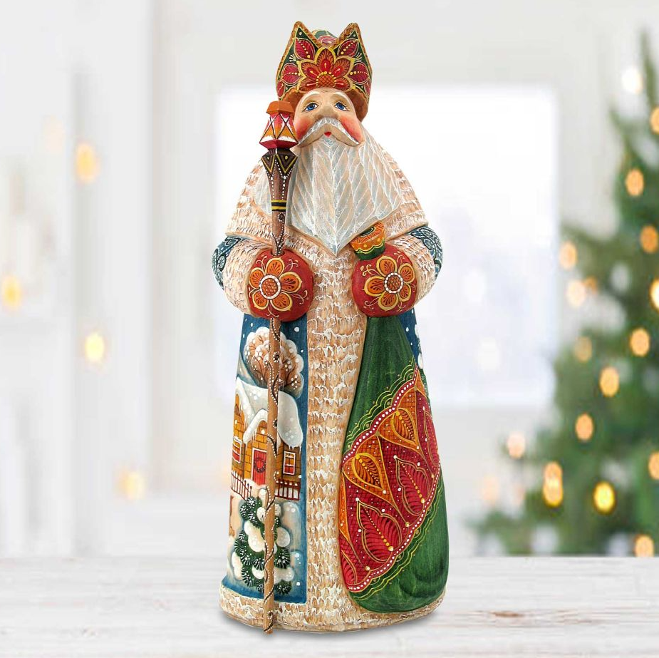 A figurine of a saint or religious figure, possibly Santa Claus, wearing a colorful and ornate costume with a hat and holding a staff.