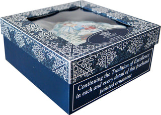 A blue and white box with a decorative pattern and a clear window, containing a painted ornament.